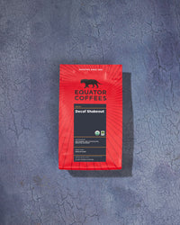 Decaf Shakeout Organic Blend | Certified Organic Decaf Coffee | Coffee Bag Backdrop | Equator Coffees